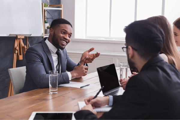 Man interviewing for a job smiling at three interviewers