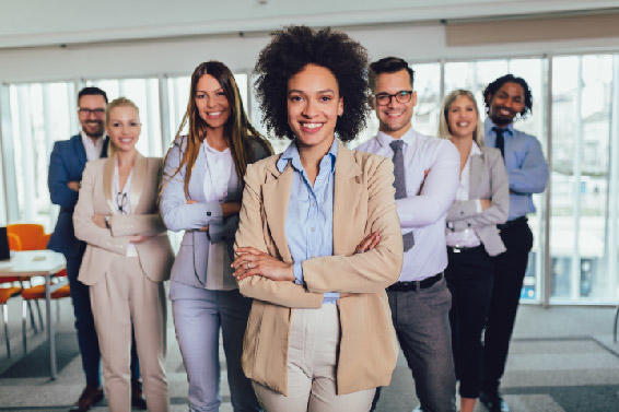 Seven smiling staff members pose with their arms crossed.